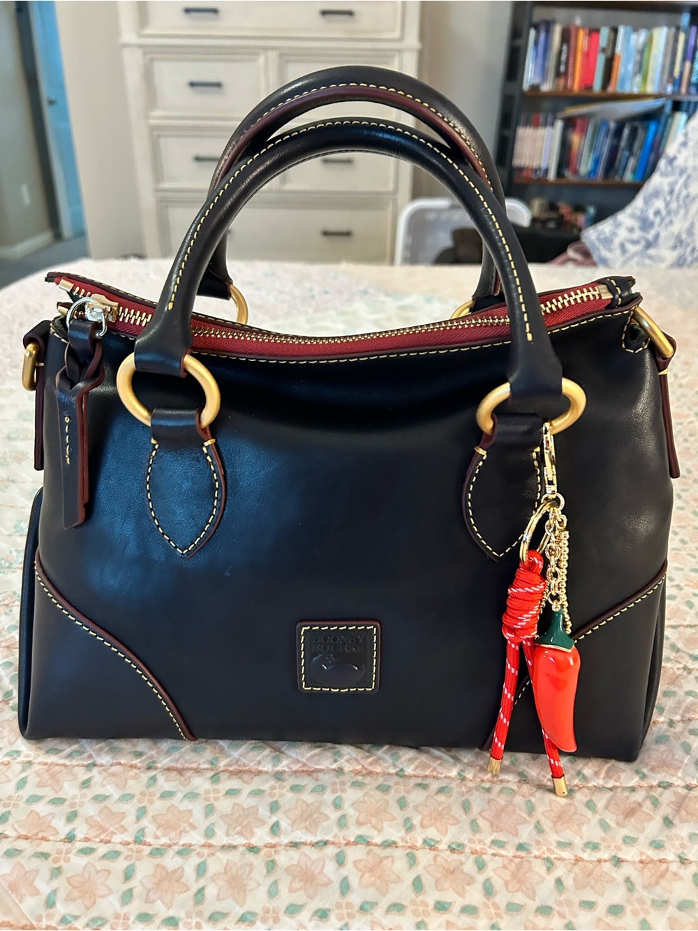 Dooney and Bourke Florentine Satchel 30 in the color Navy. EUC comes w/bag charm